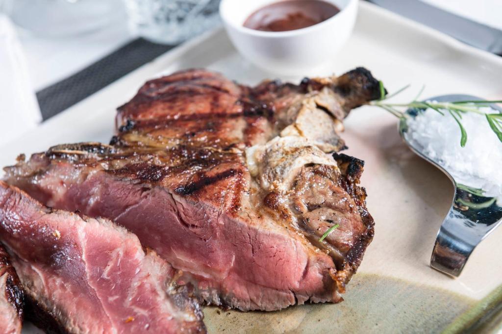 Dinner downstairs — the bistecca, sea salt, rosemary, a quiet table