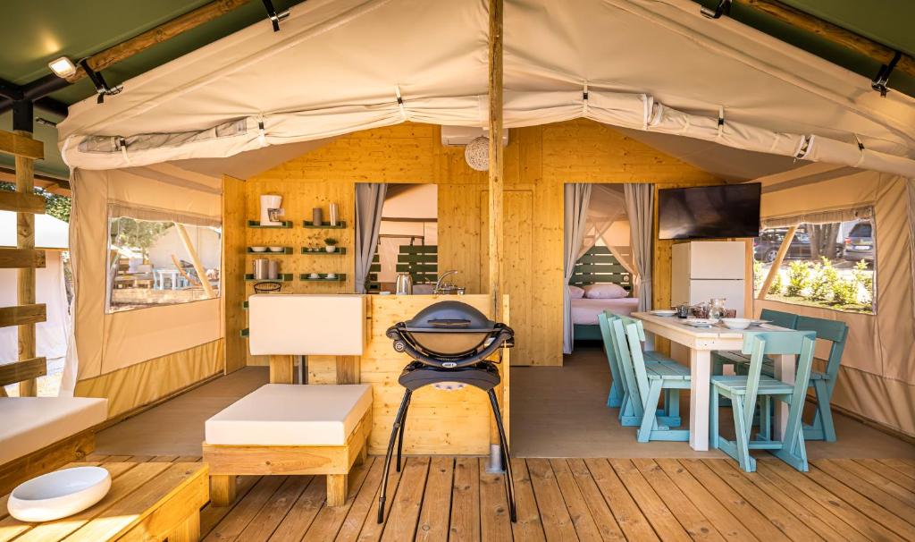 Inside the tent — kitchen, dining table, bedroom beyond